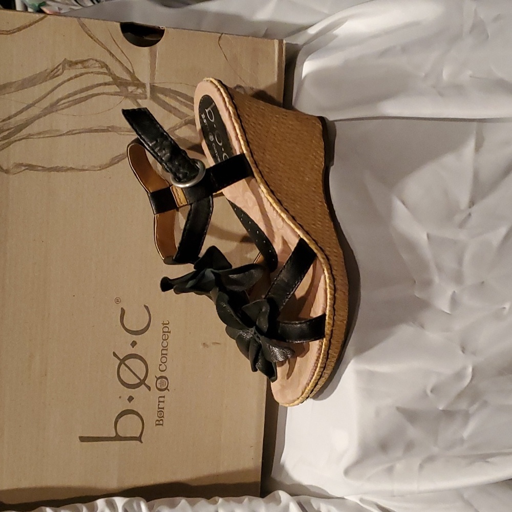 Born concept wedge. Heel is padded. Black floral strap design. Size 6
